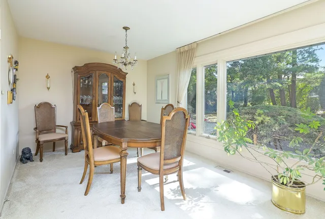 a dining room with furniture window and outside view