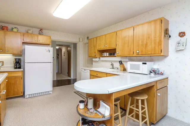 a kitchen with stainless steel appliances a stove a refrigerator and a sink