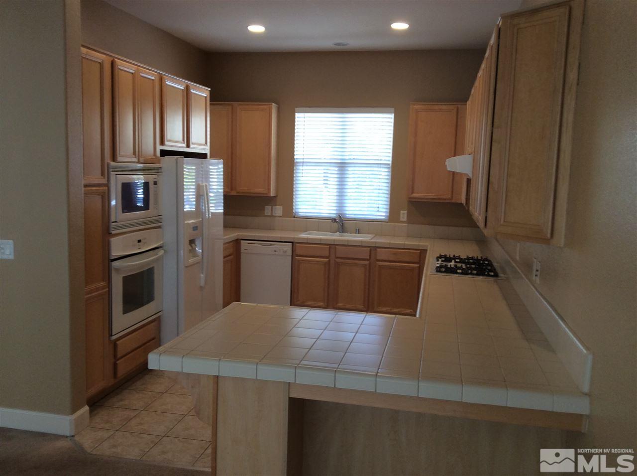 1660 Sawtooth Trail Reno, NV 89523 - Photo 2 of 18 a kitchen with stainless steel appliances a refrigerator sink and cabinets