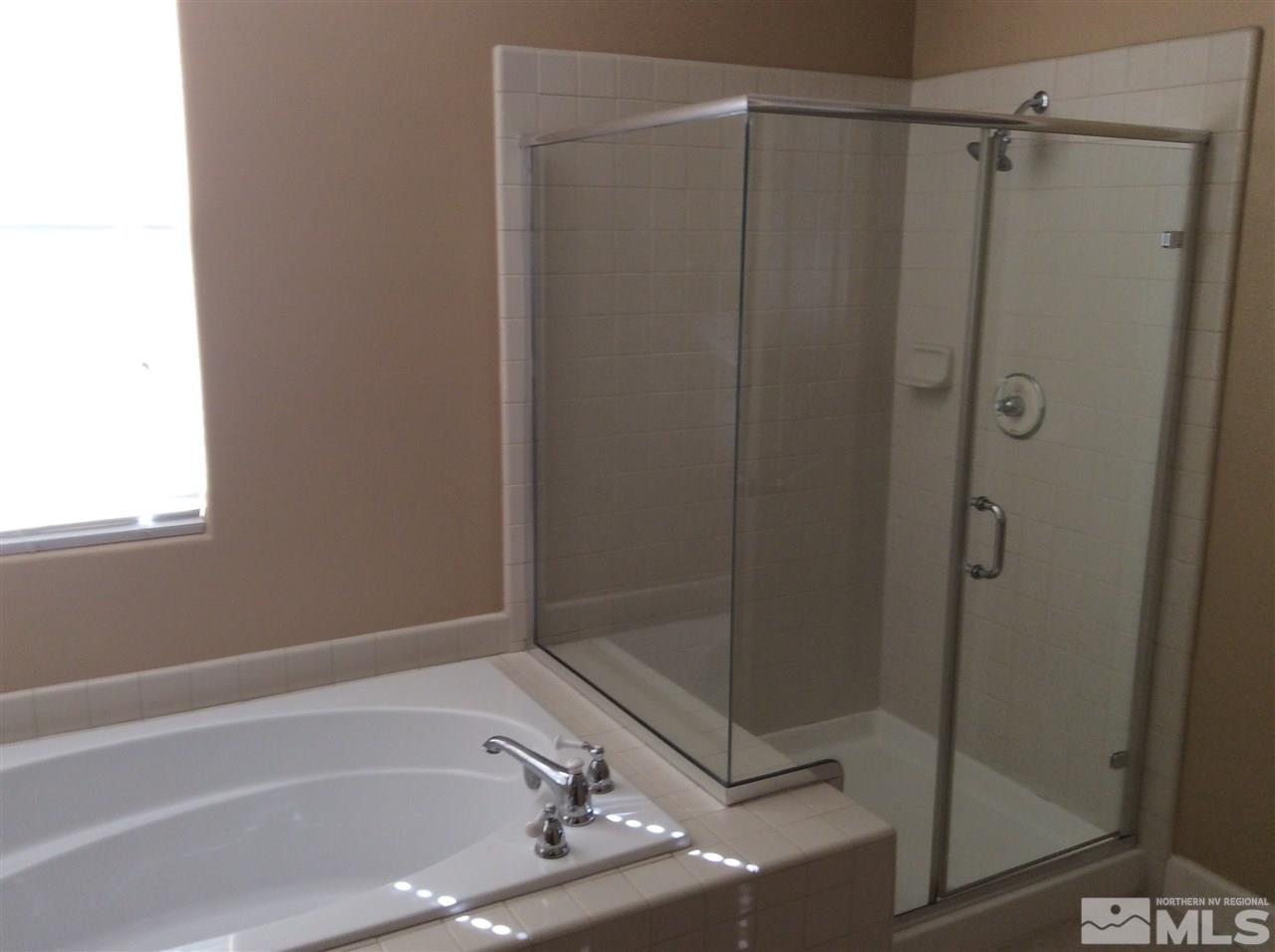 1660 Sawtooth Trail Reno, NV 89523 - Photo 9 of 18 a bathroom with a bathtub and a shower
