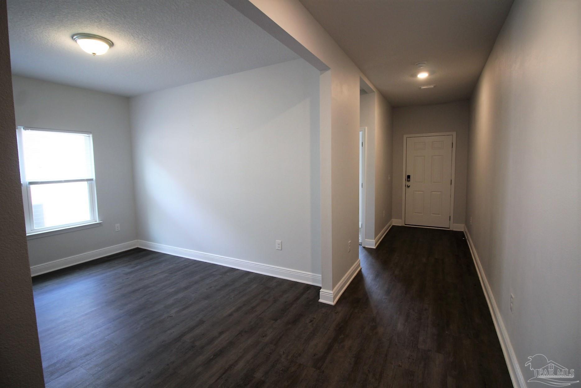 8006 Burnside Loop Pensacola, FL 32526 - Photo 5 of 22 an empty room with wooden floor and windows