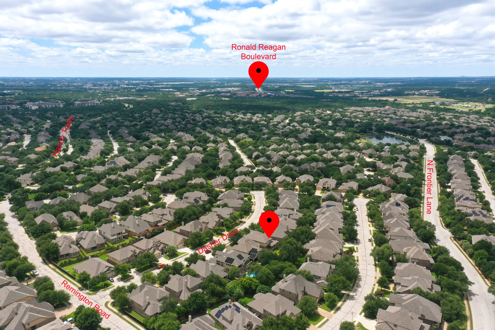 110 Dasher Drive Cedar Park, TX 78613 - Photo 34 of 39 An aerial perspective showcases a residential neighborhood amidst a verdant landscape under a bright sky.