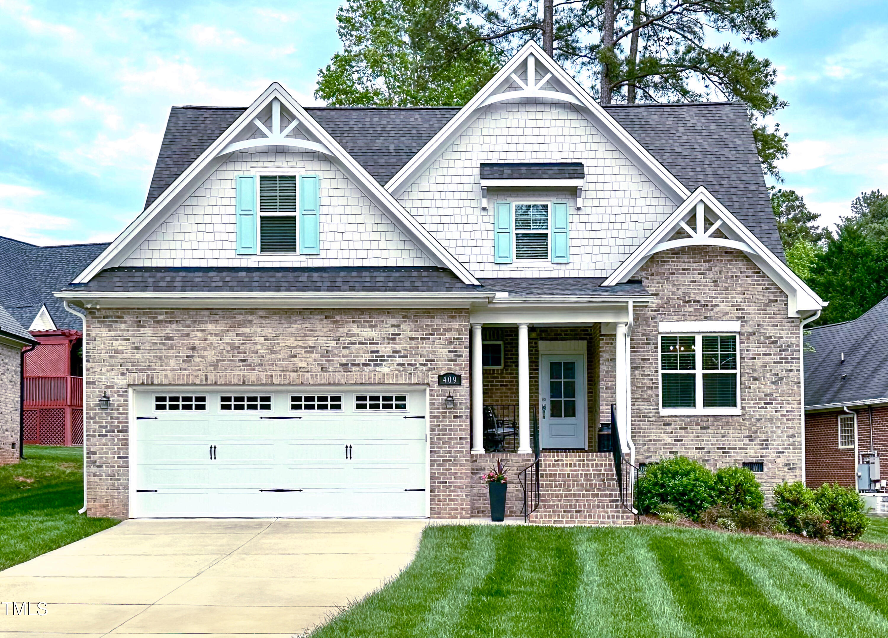 front view of a house with a yard