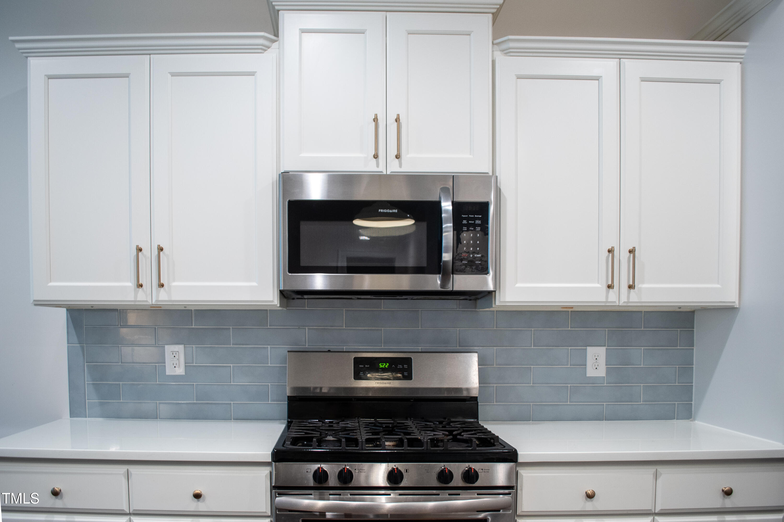 409 Eagle Court Henderson, NC 27536 - Photo 13 of 54 a kitchen with a stove and white cabinets