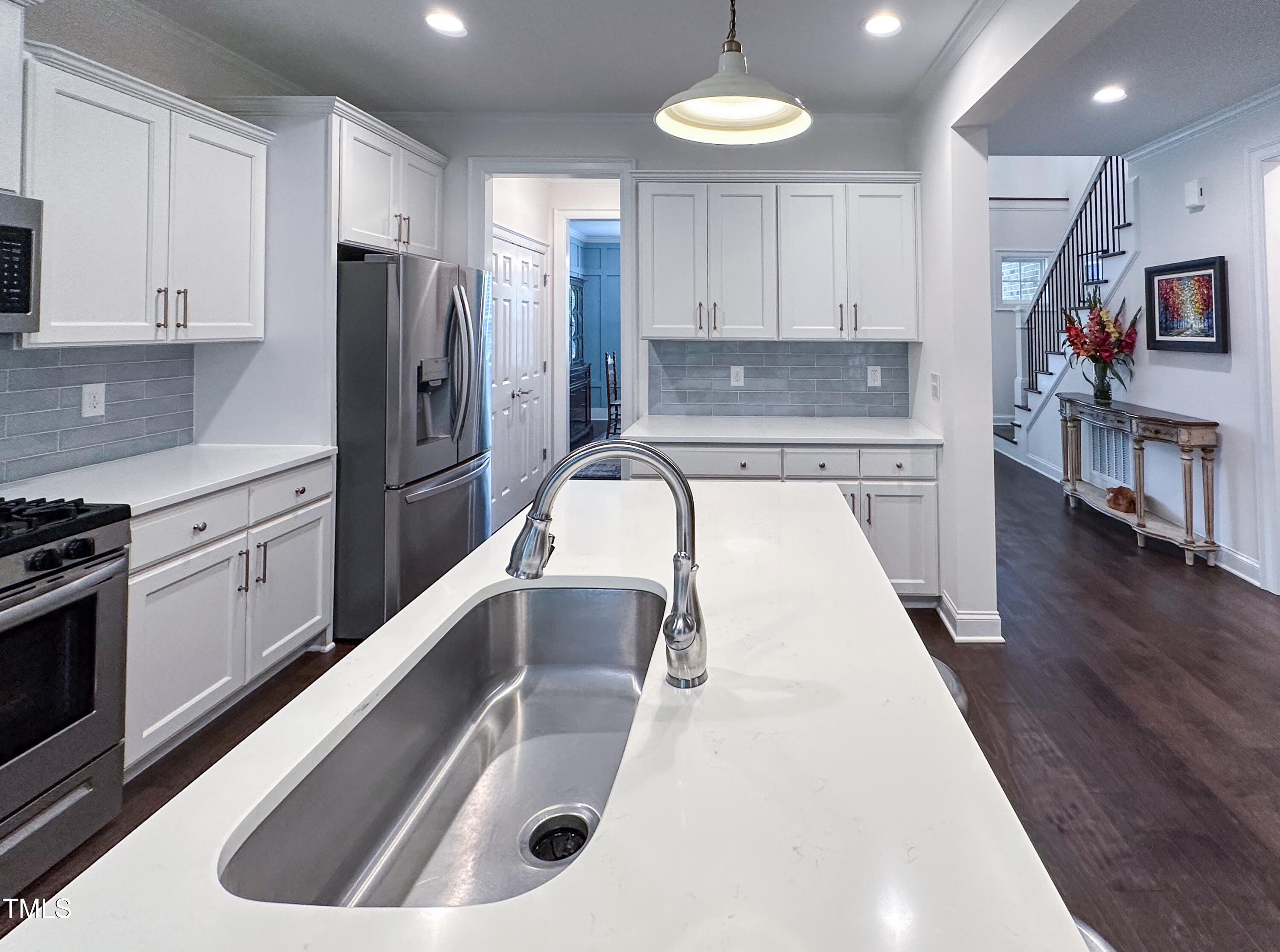 409 Eagle Court Henderson, NC 27536 - Photo 16 of 54 a kitchen with stainless steel appliances granite countertop a sink a stove and a refrigerator with wooden floor