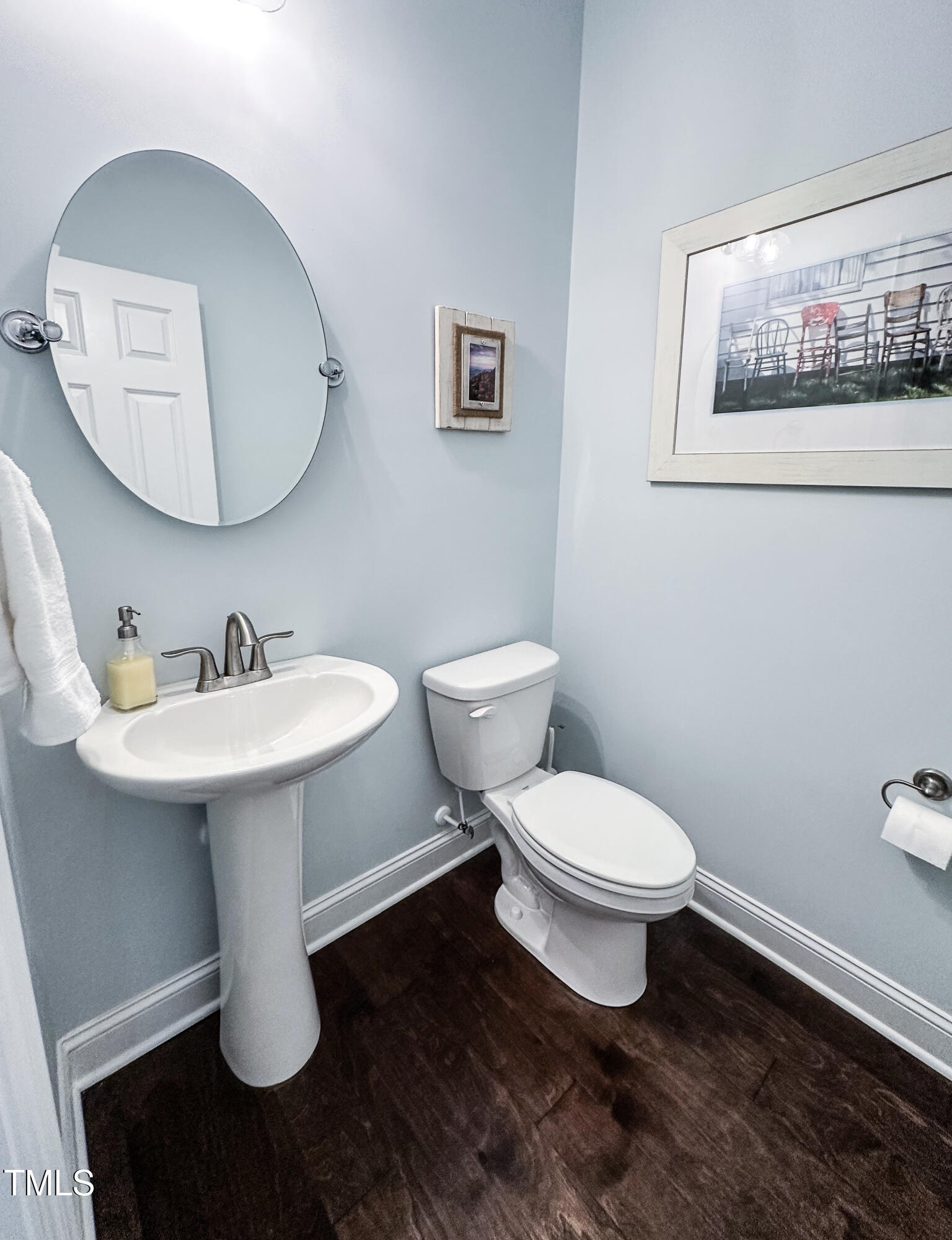 409 Eagle Court Henderson, NC 27536 - Photo 18 of 54 a bathroom with a toilet a sink and mirror