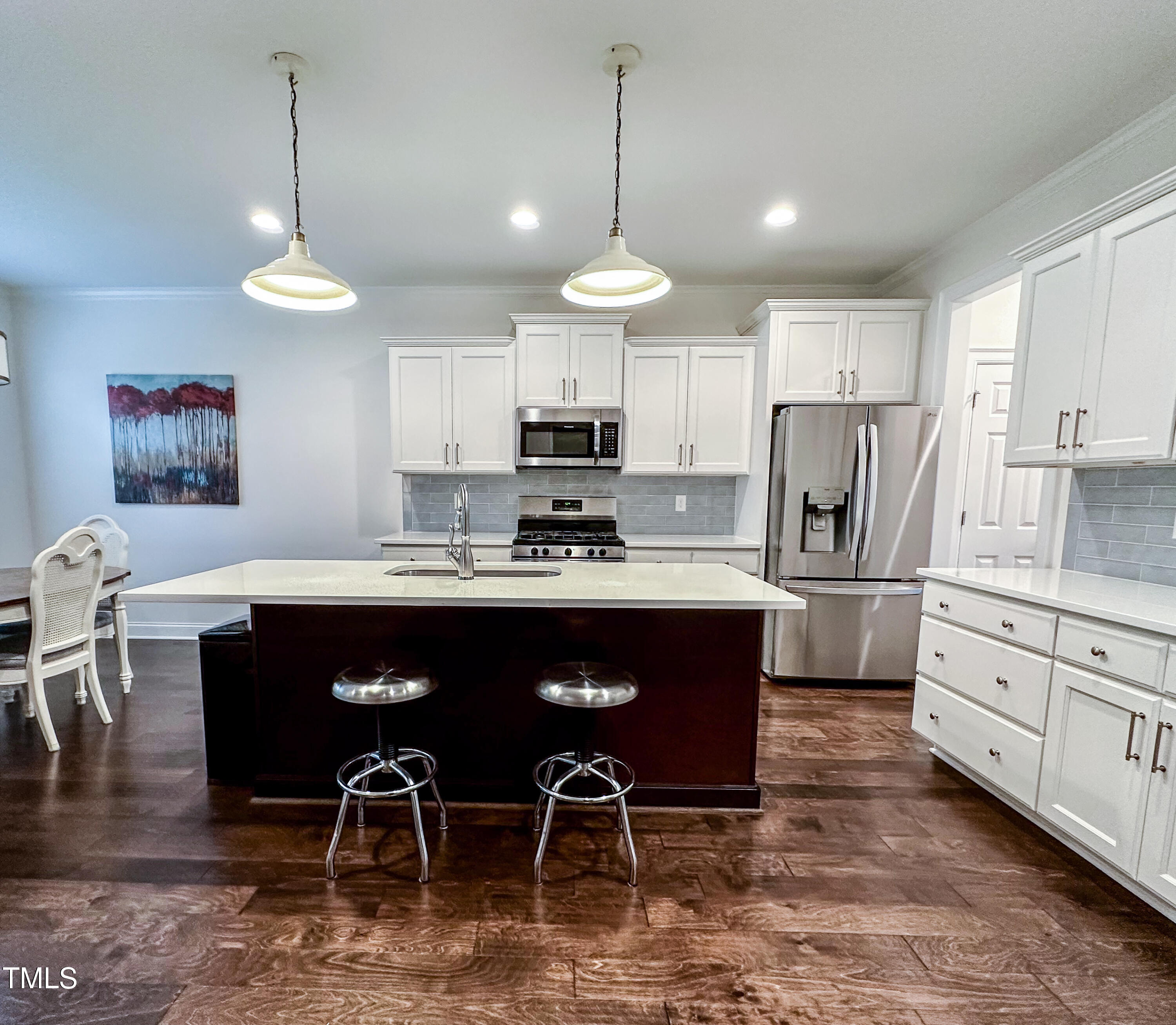 409 Eagle Court Henderson, NC 27536 - Photo 2 of 54 a kitchen with stainless steel appliances granite countertop a refrigerator a stove a sink a dining table and chairs
