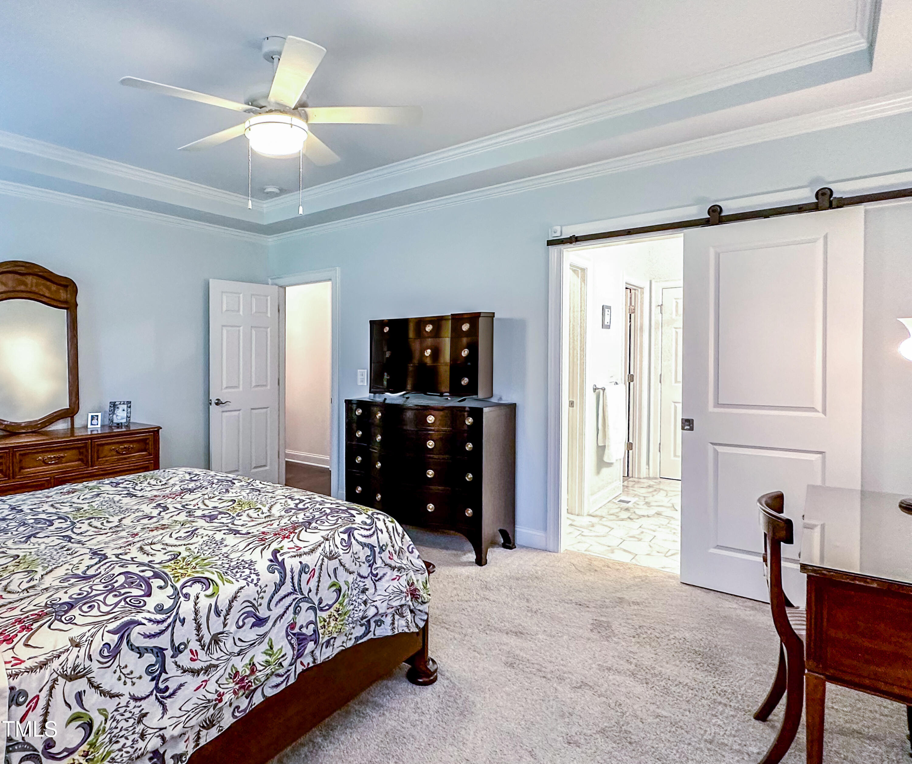 409 Eagle Court Henderson, NC 27536 - Photo 21 of 54 a bedroom with a bed and a chandelier