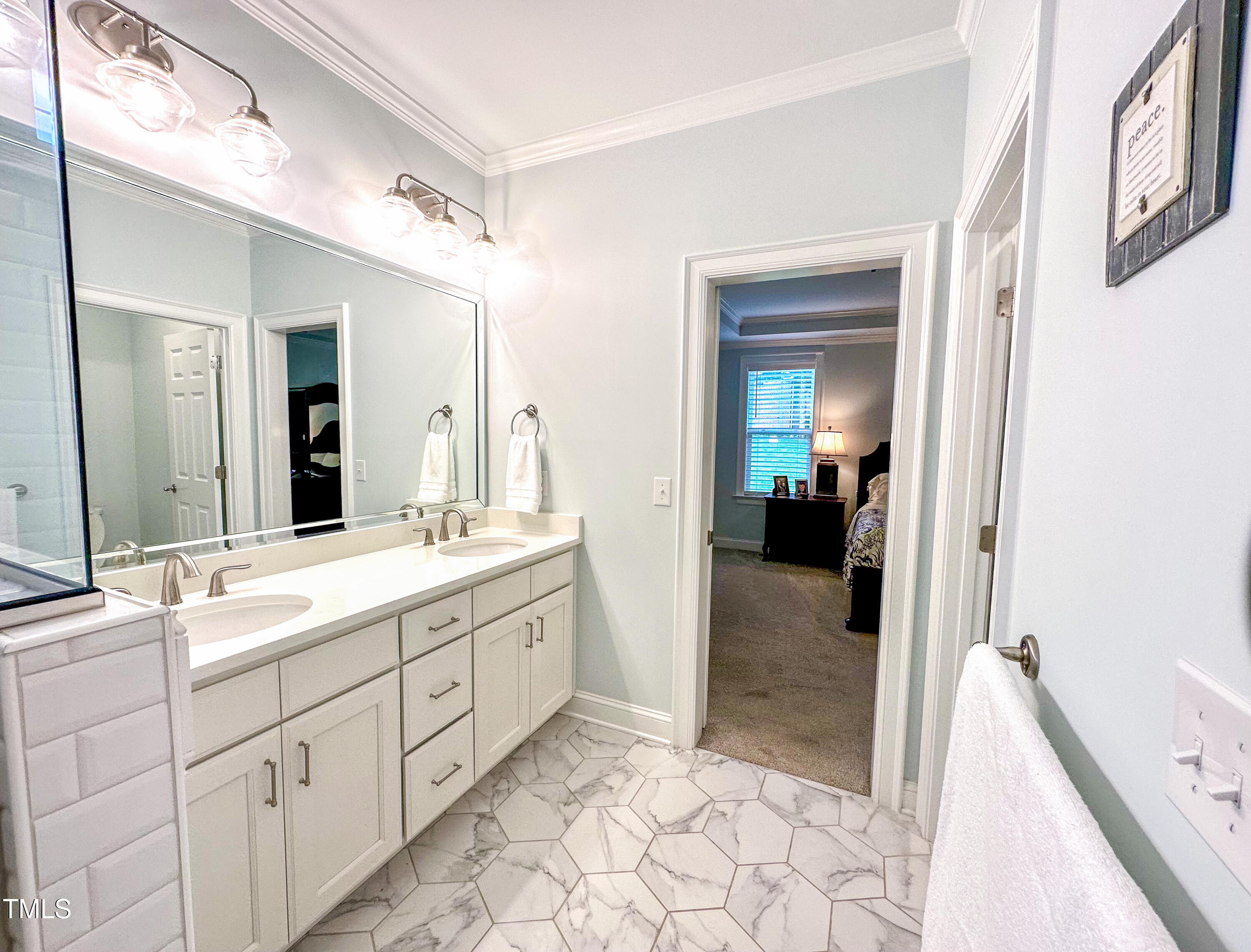 409 Eagle Court Henderson, NC 27536 - Photo 23 of 54 a spacious bathroom with a shower sink and mirror