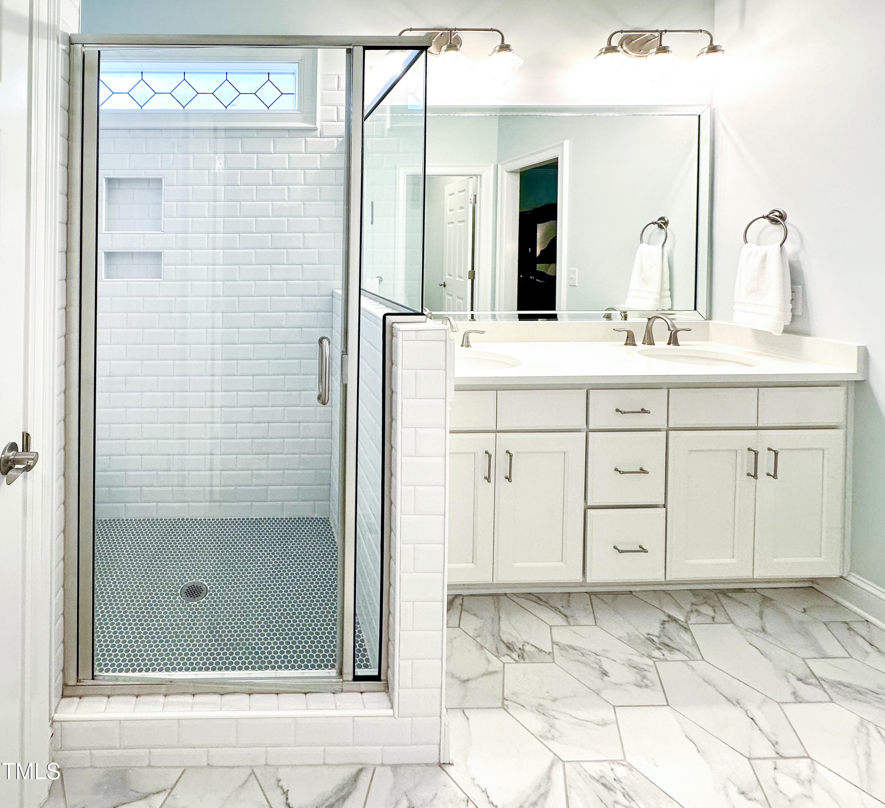 409 Eagle Court Henderson, NC 27536 - Photo 24 of 54 a bathroom with a shower sink and mirror