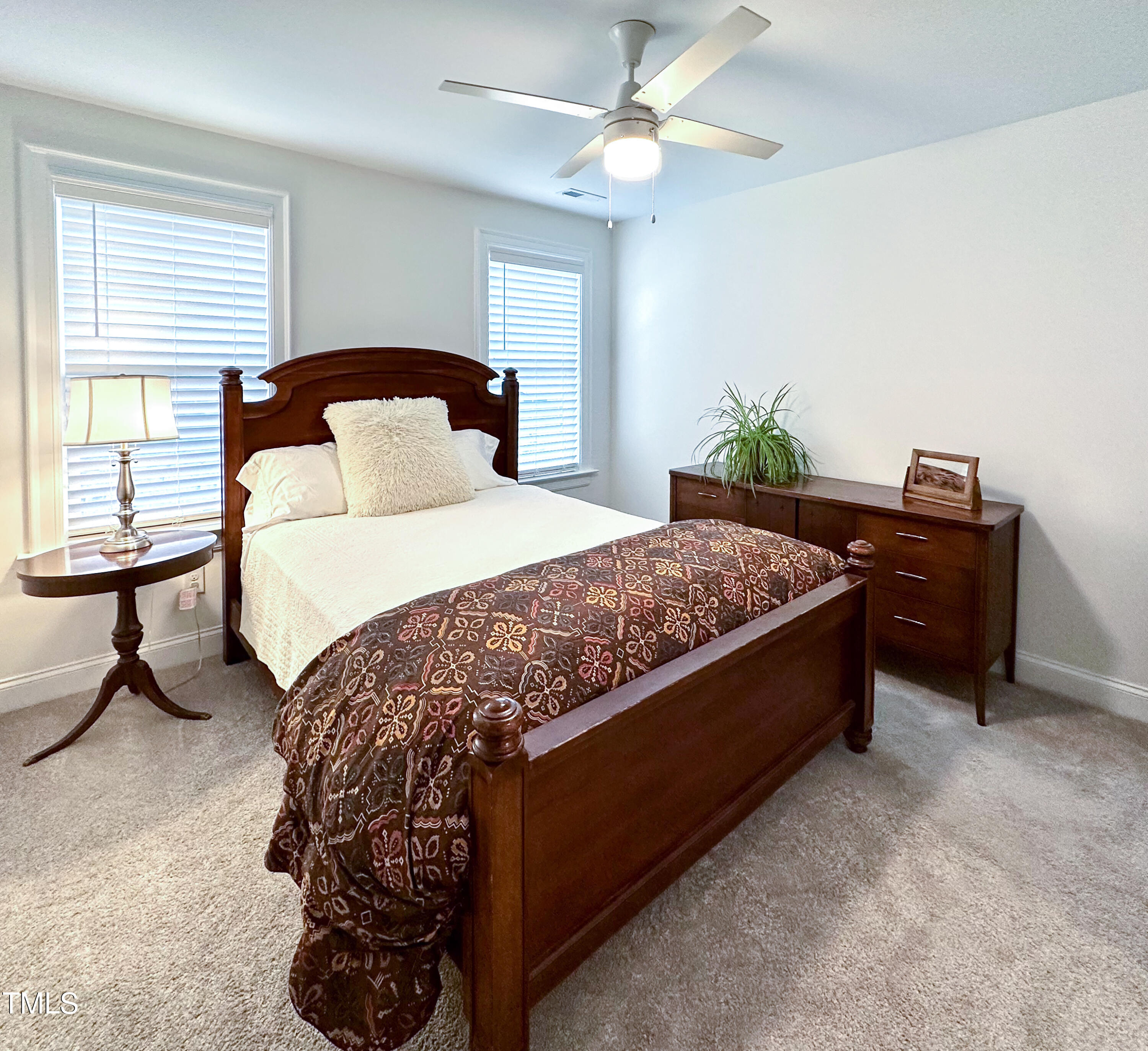 409 Eagle Court Henderson, NC 27536 - Photo 29 of 54 a bedroom with a bed and a chandelier