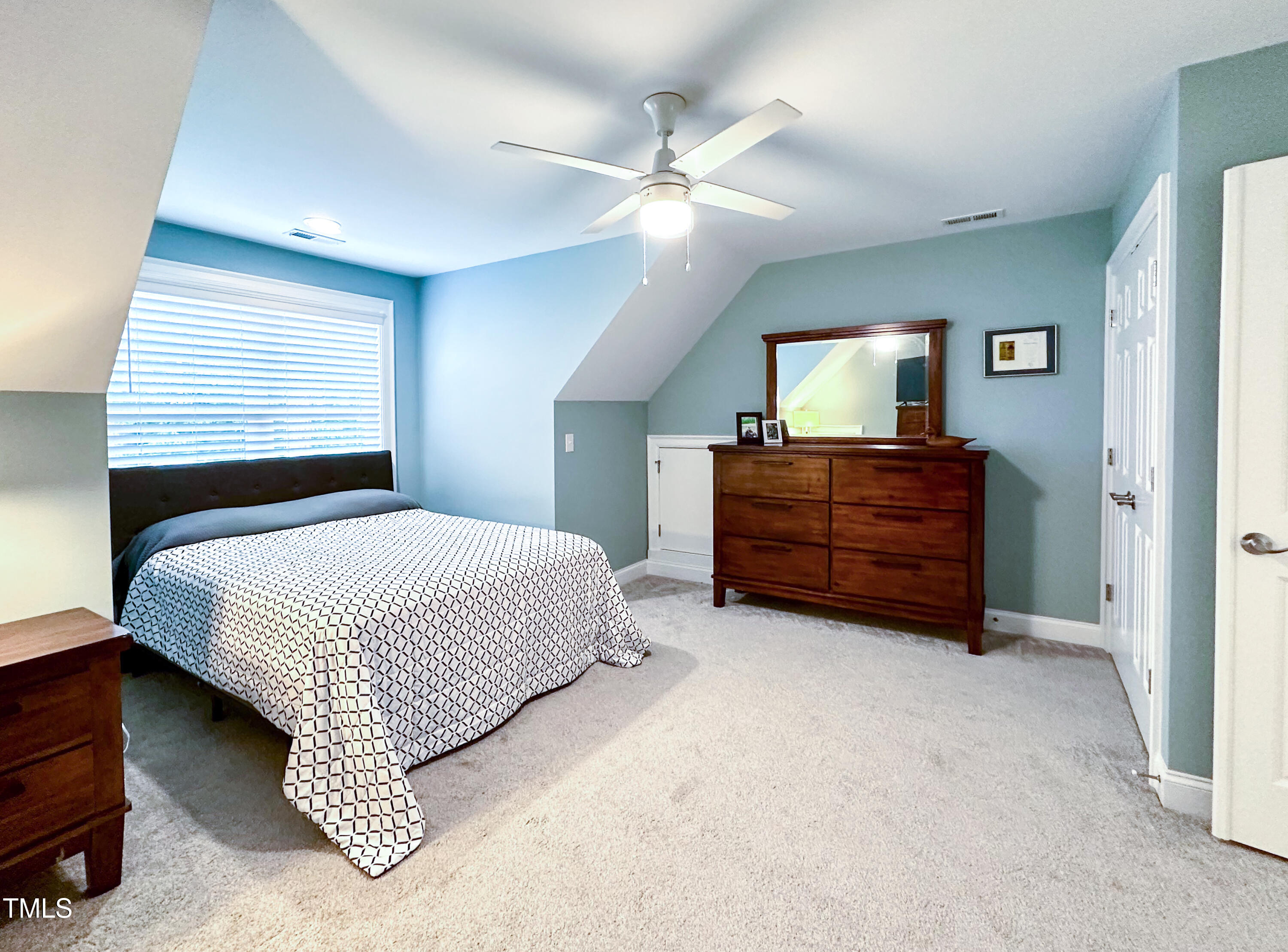409 Eagle Court Henderson, NC 27536 - Photo 31 of 54 a spacious bedroom with a bed and a chandelier