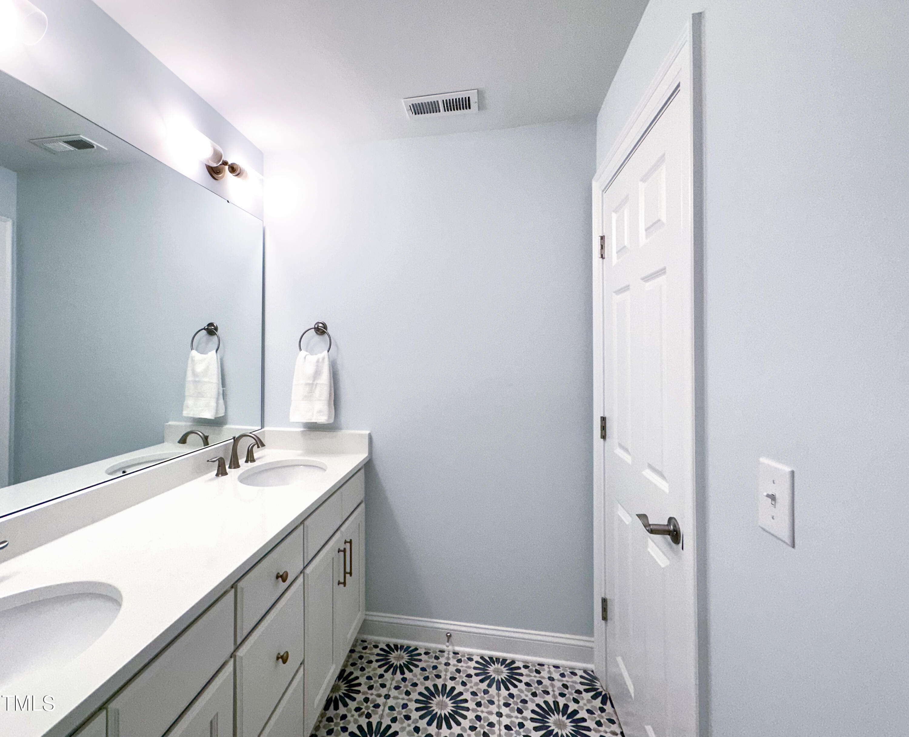 409 Eagle Court Henderson, NC 27536 - Photo 34 of 54 a bathroom with a sink and a mirror