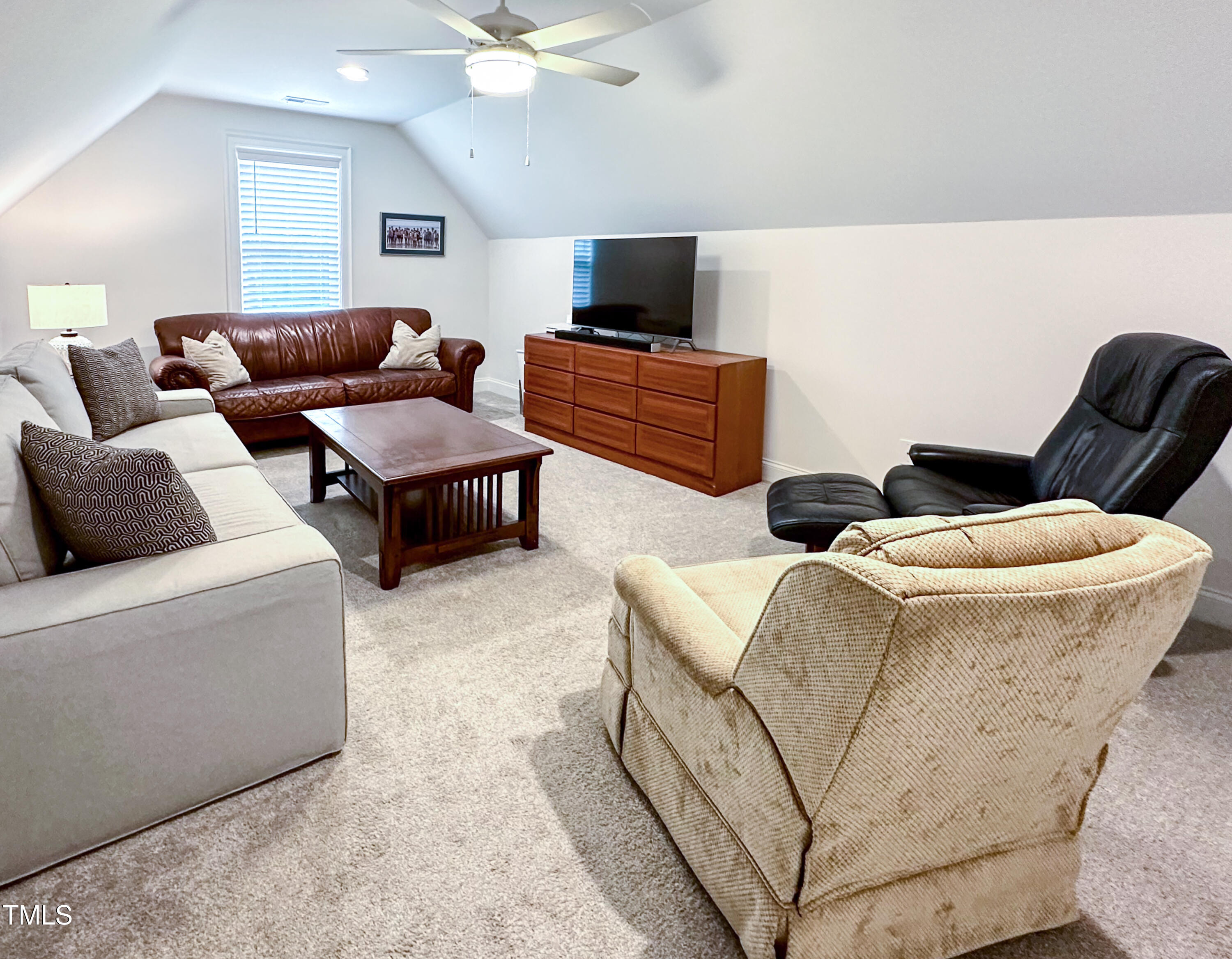 409 Eagle Court Henderson, NC 27536 - Photo 38 of 54 a living room with furniture and a flat screen tv