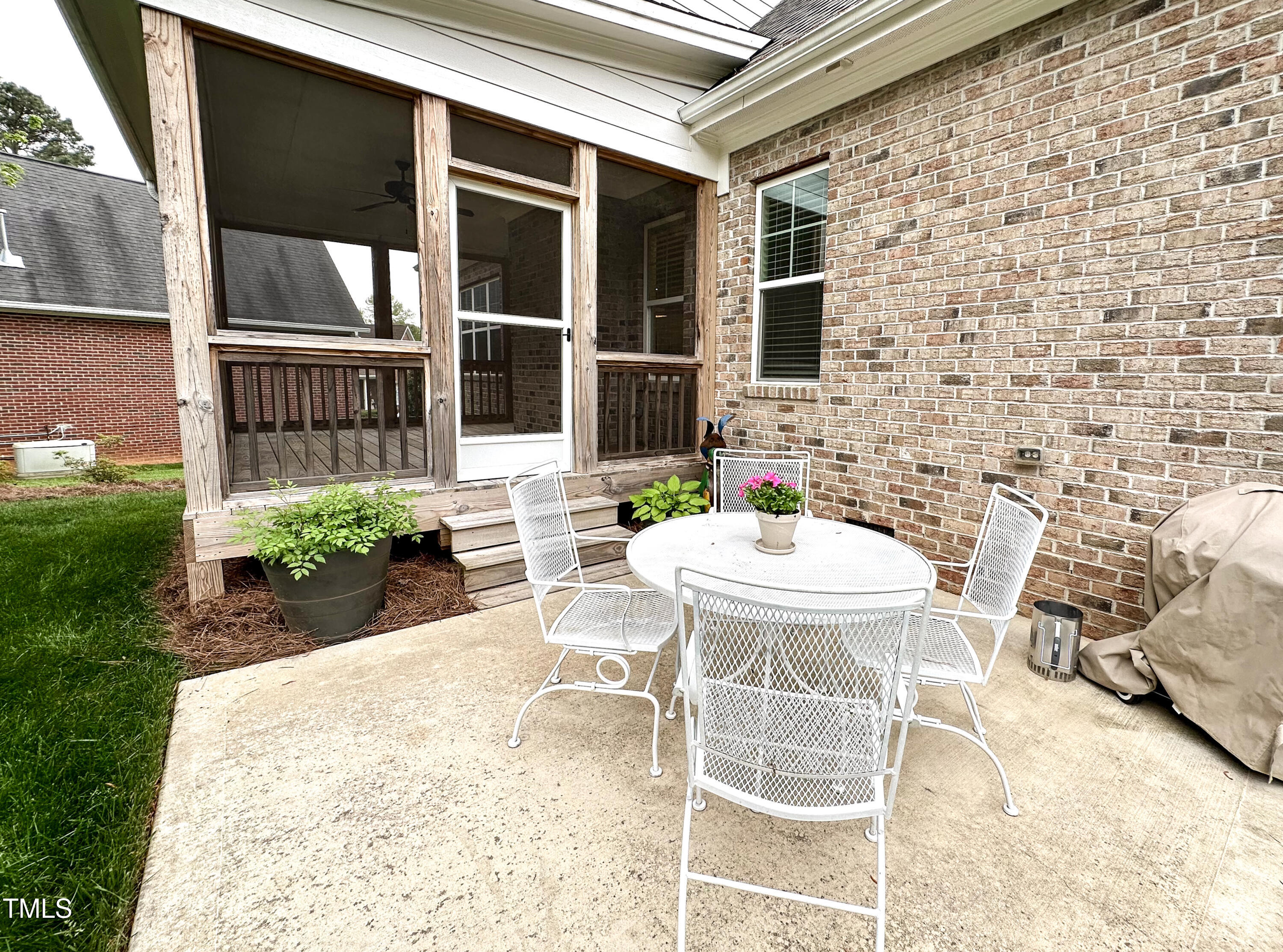 409 Eagle Court Henderson, NC 27536 - Photo 39 of 54 a view of a patio with table and chairs and potted plants