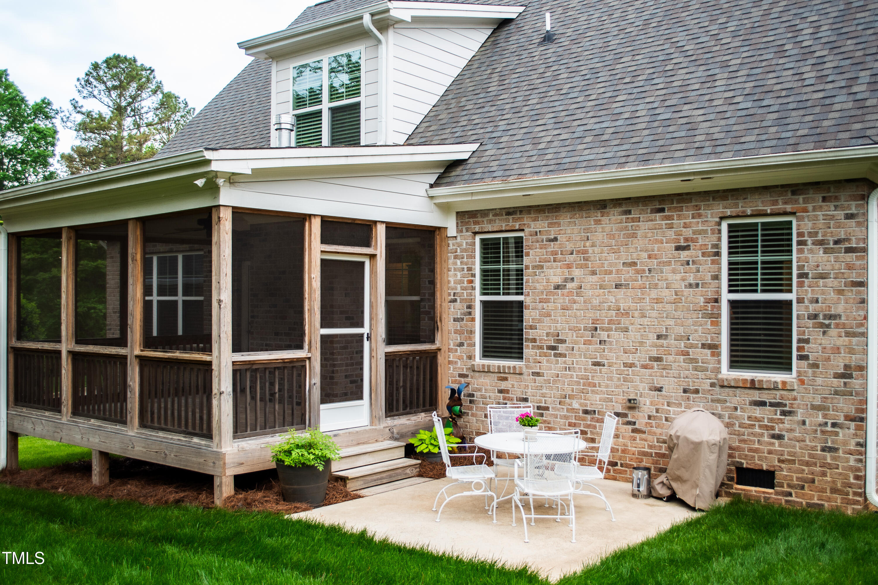 409 Eagle Court Henderson, NC 27536 - Photo 42 of 54 a view of a patio with table and chairs