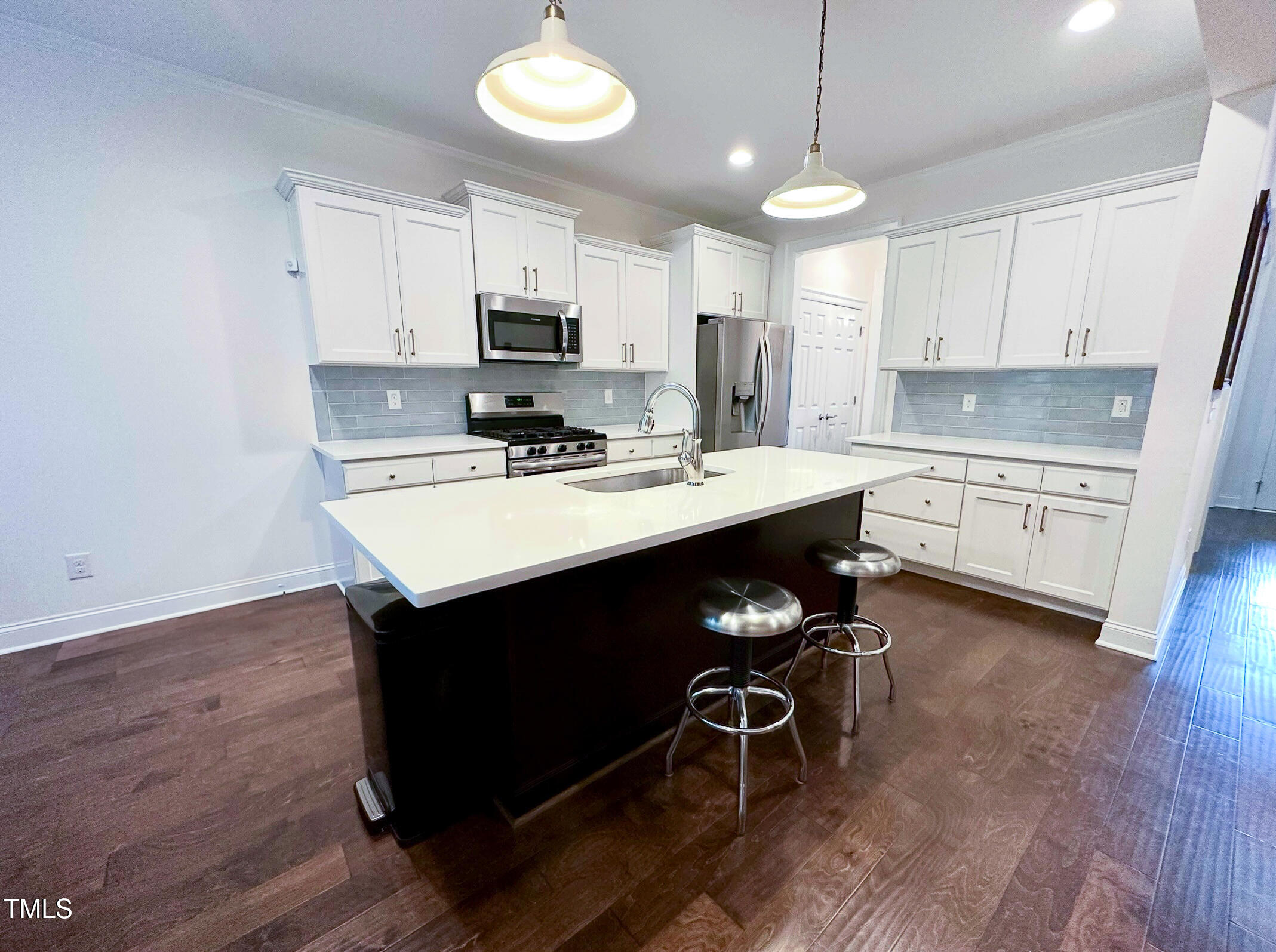 409 Eagle Court Henderson, NC 27536 - Photo 9 of 54 a kitchen with stainless steel appliances a stove a sink dishwasher a microwave oven with cabinets and wooden floor