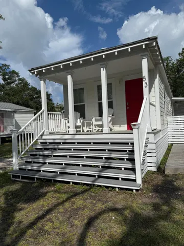 a view of a house with a balcony wooden fence