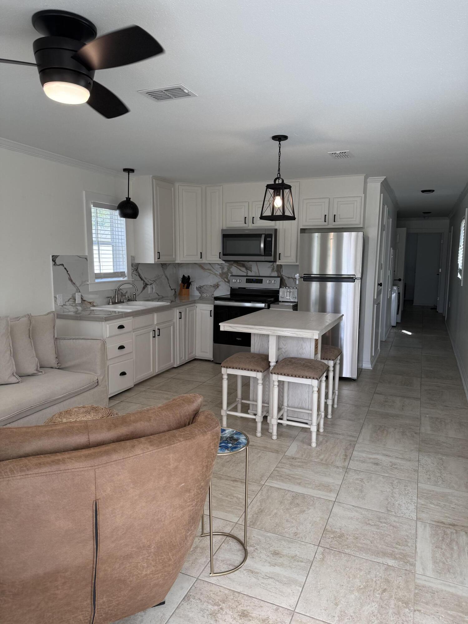 53 State Street Freeport, FL 32439 - Photo 3 of 11 a kitchen with stainless steel appliances a stove a refrigerator and cabinets