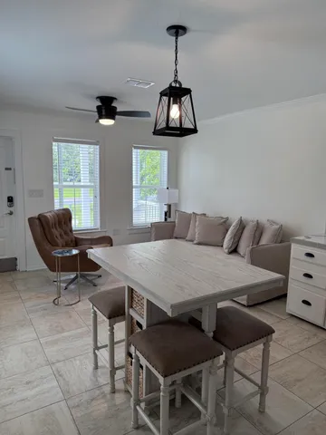 a view of a dining room with furniture window and outside view