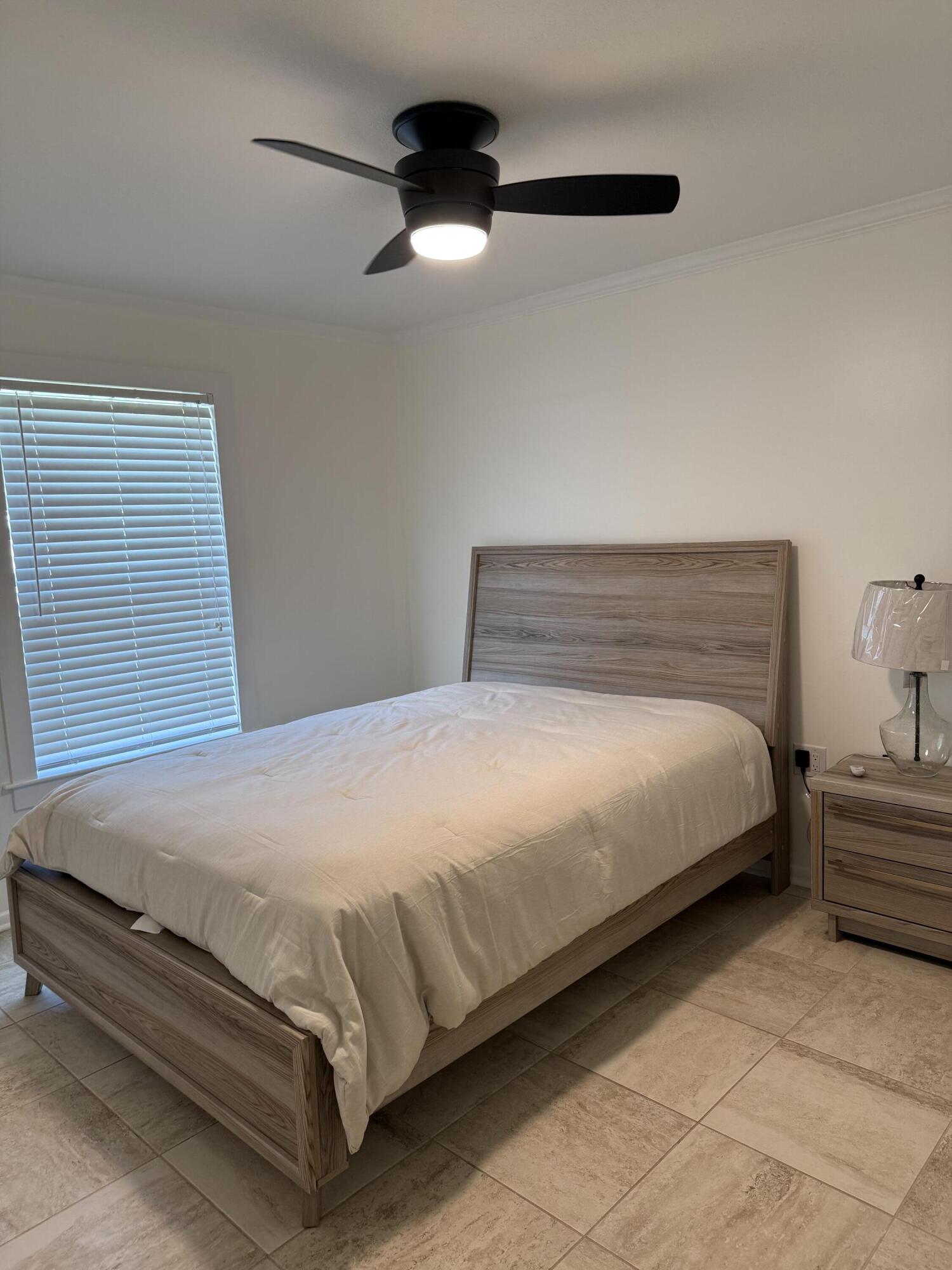 53 State Street Freeport, FL 32439 - Photo 7 of 11 a bedroom with a bed and a ceiling fan