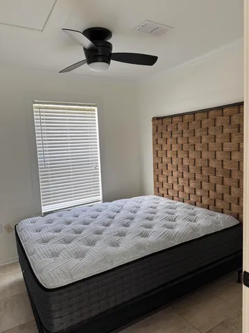 a view of an empty room with closet and mirror