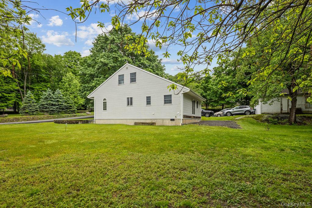 289 Seven Springs Mountain Road Monroe, NY 10950 - Photo 24 of 25 a view of a backyard with plants and large trees