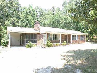 715 Bahama Road Bahama, NC 27503 - Photo 1 of 1 a front view of a house with a yard and garage