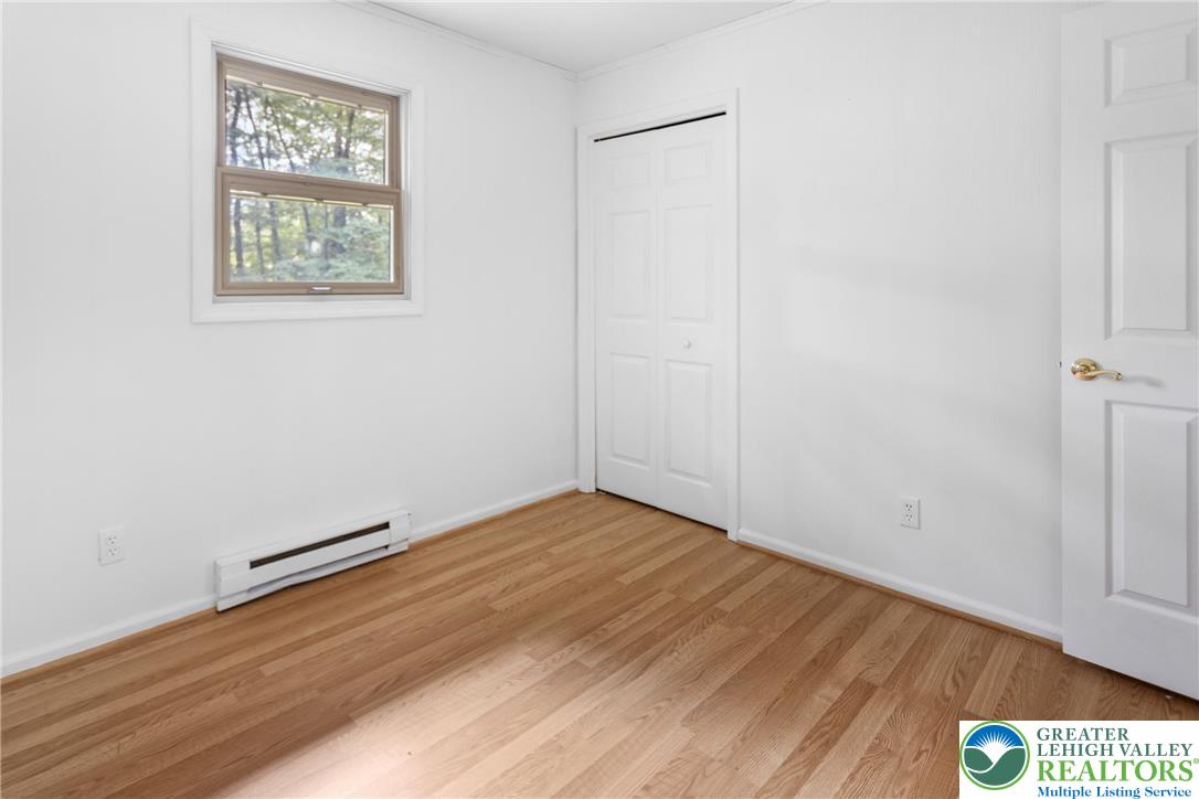 3571 Oak Ridge Drive Slatington, PA 18080 - Photo 16 of 43 an empty room with wooden floor and windows