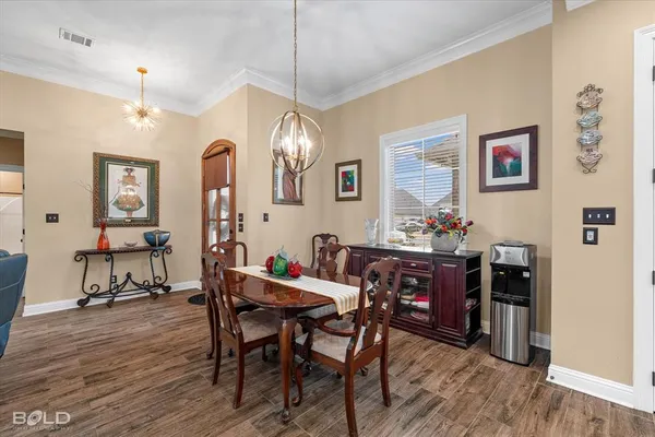 a view of a dining room with furniture and wooden floor