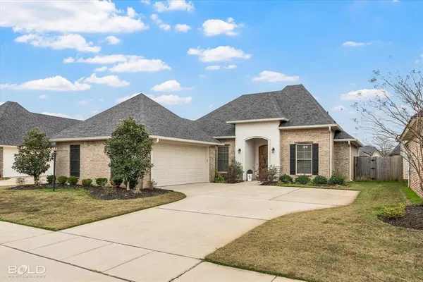 a front view of a house with yard