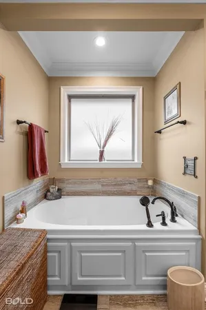 a bathroom with a granite countertop sink and a bathtub