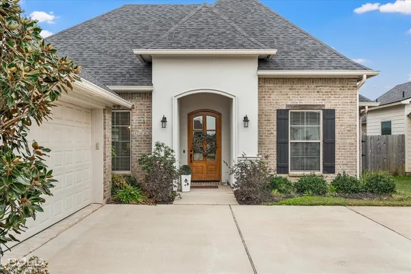 front view of a house with potted plants