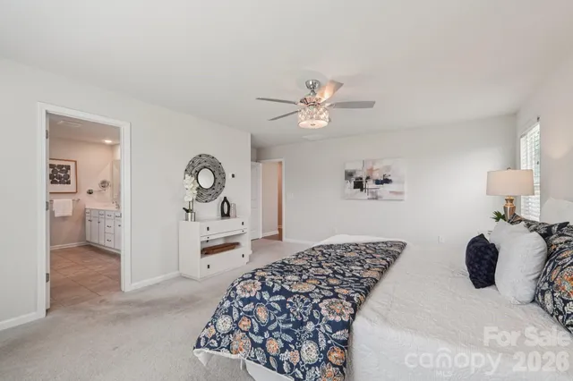 a spacious bathroom with a granite countertop sink mirror and shower