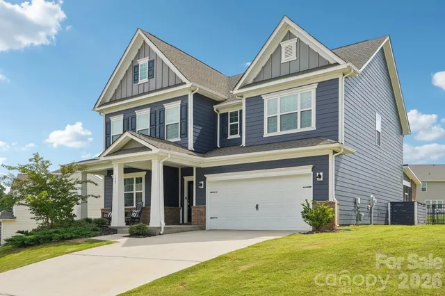 a living room with furniture fireplace and a large window