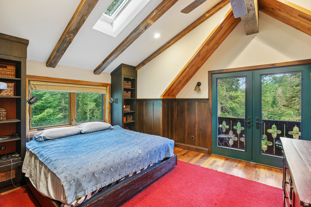 10205 East Moose Loop Road Salt Lake City, UT 84121 - Photo 17 of 50 Vaulted ceiling with exposed wood beams, skylight, and wood-finish flooring