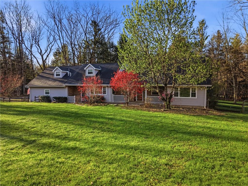7092 Mercer Road Polk, PA 16342 - Photo 1 of 50 a front view of a house with a garden