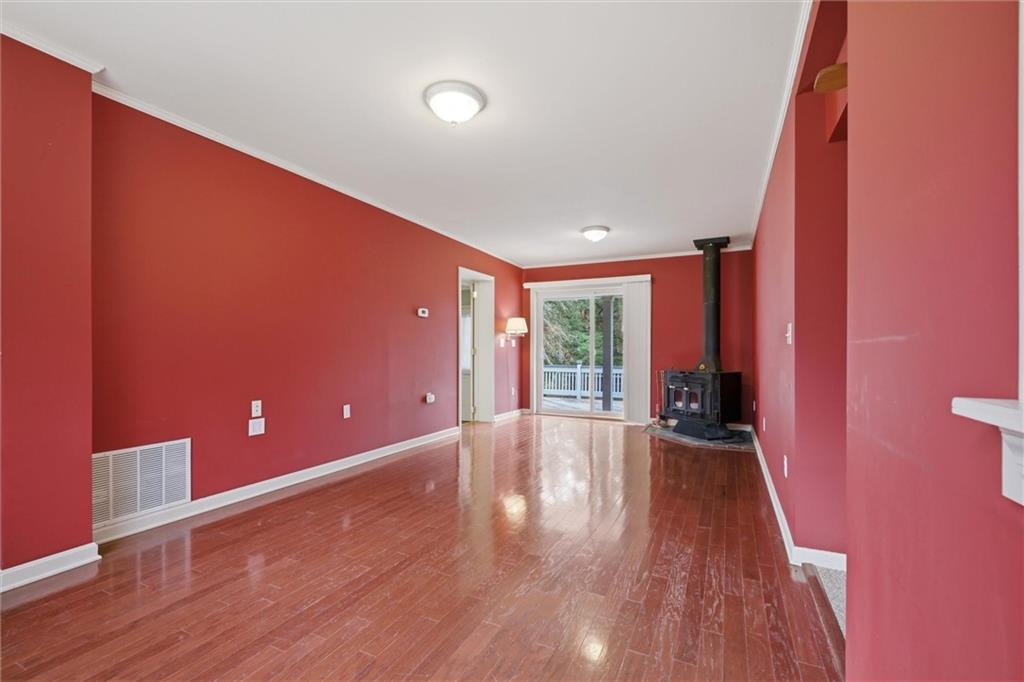 7092 Mercer Road Polk, PA 16342 - Photo 19 of 50 a view of an empty room with wooden floor and a window