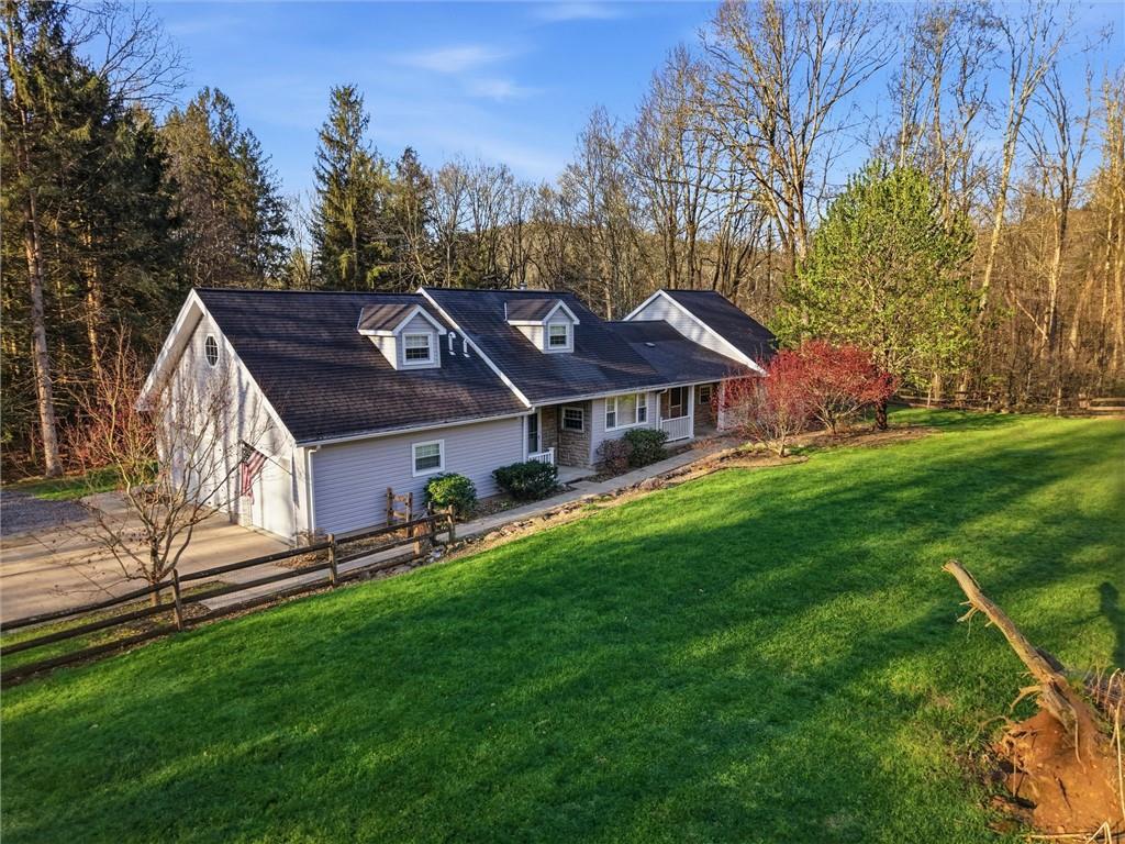 7092 Mercer Road Polk, PA 16342 - Photo 38 of 50 a front view of house with yard and trees in the background