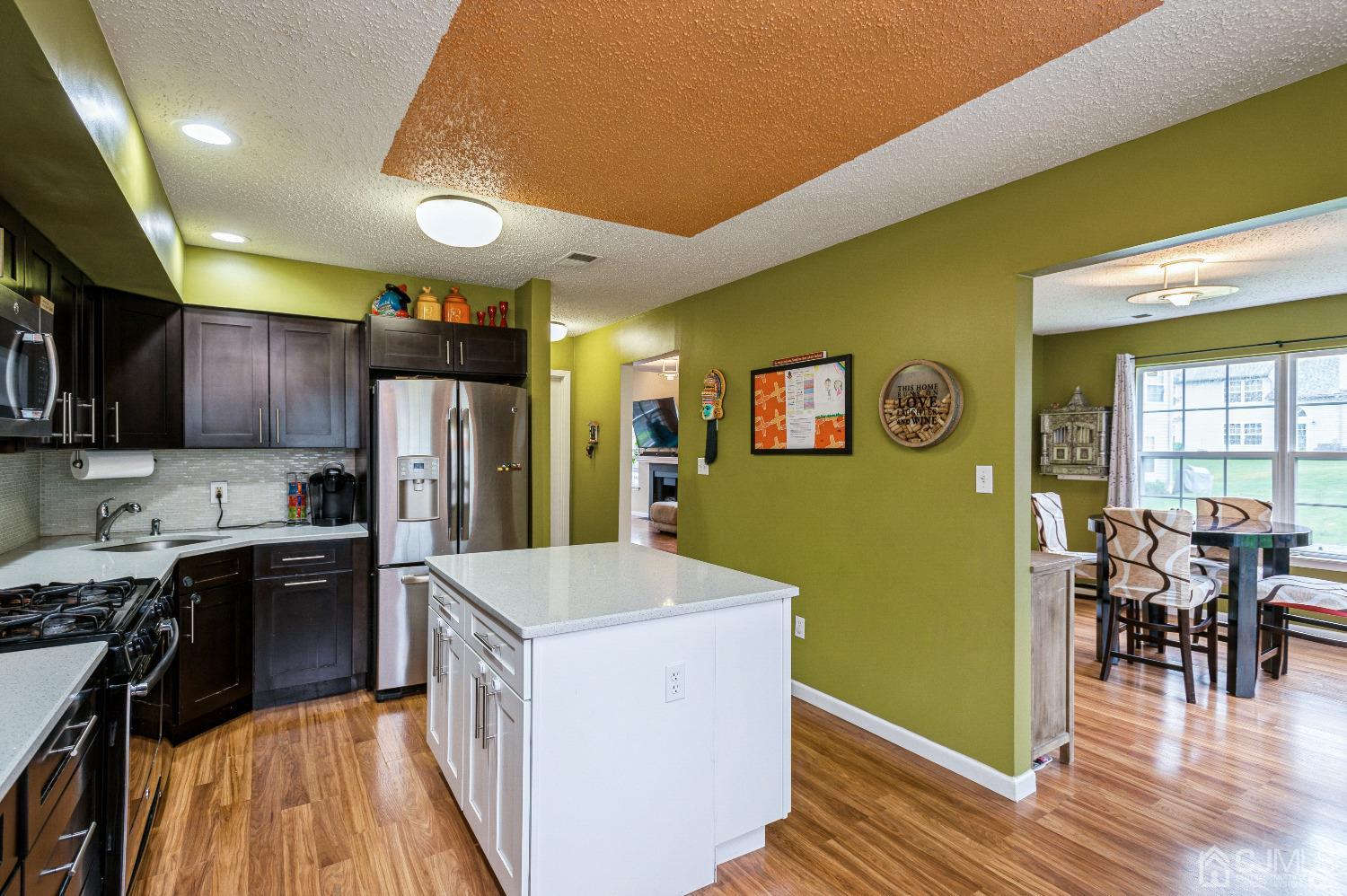 409 Draco Road Piscataway, NJ 08854 - Photo 11 of 28 a kitchen with cabinets and wooden floor