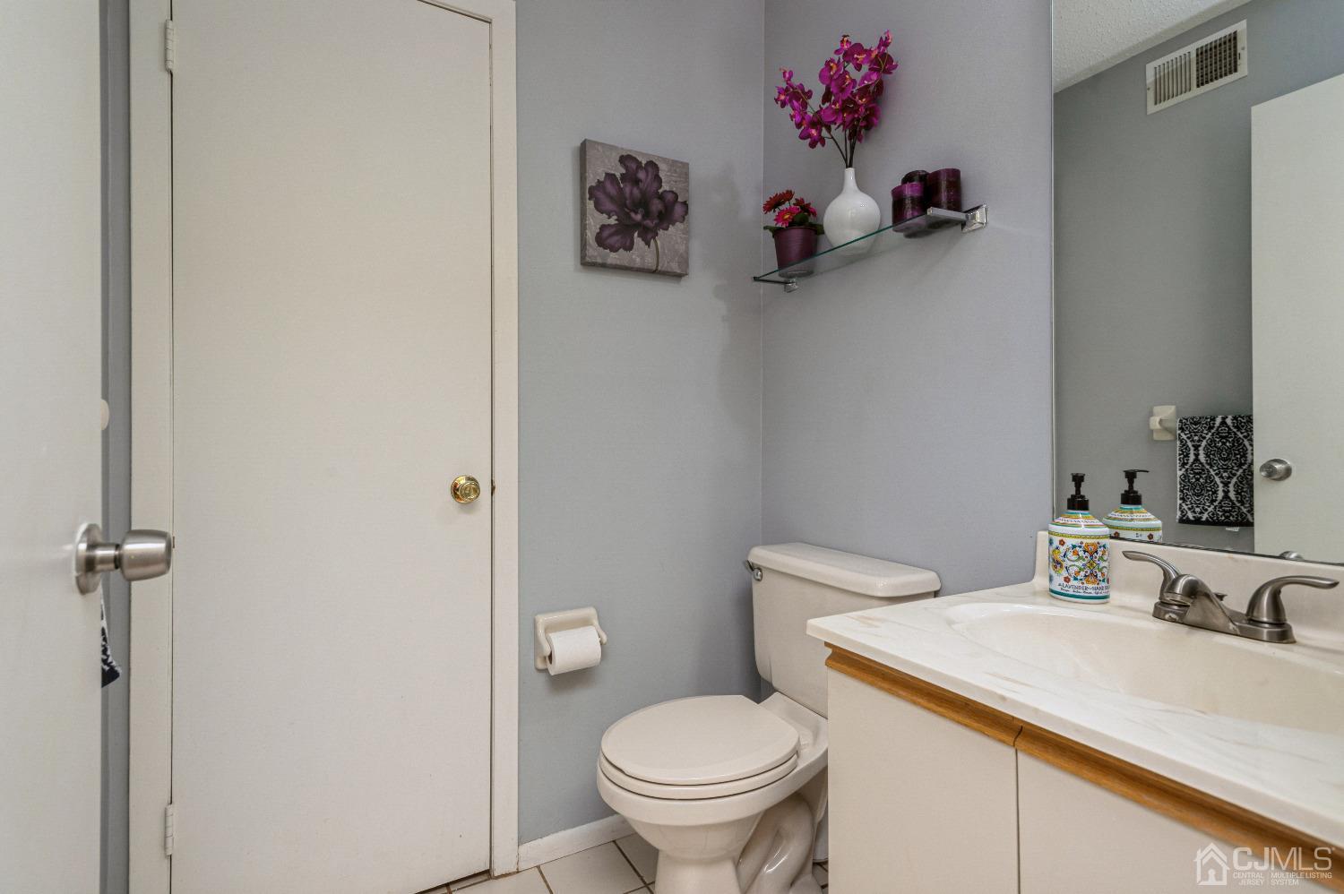 409 Draco Road Piscataway, NJ 08854 - Photo 15 of 28 a bathroom with a toilet sink and mirror