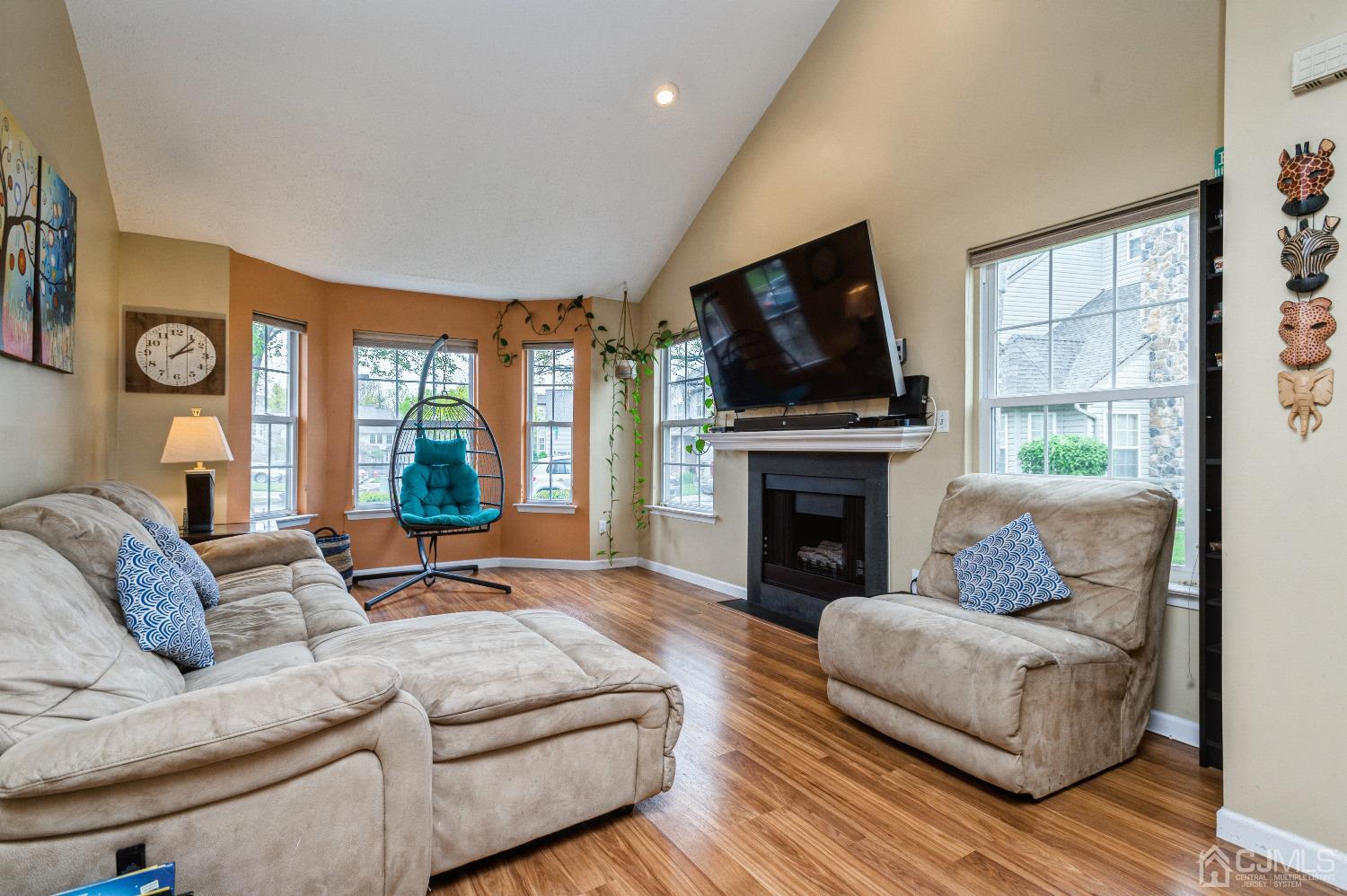 409 Draco Road Piscataway, NJ 08854 - Photo 7 of 28 a living room with furniture a flat screen tv and a fireplace