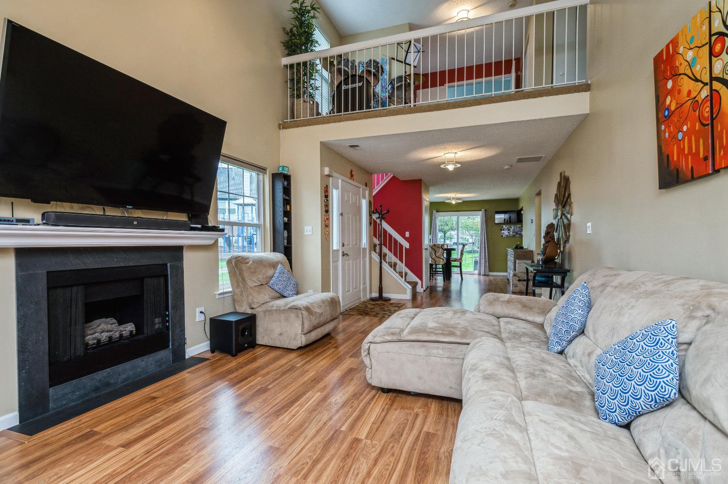 409 Draco Road Piscataway, NJ 08854 - Photo 9 of 28 a living room with furniture a flat screen tv and a fireplace