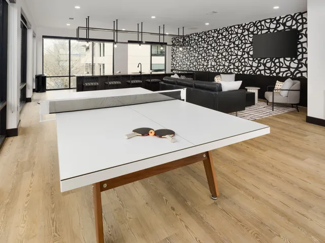 a kitchen with stainless steel appliances a dining table and chairs