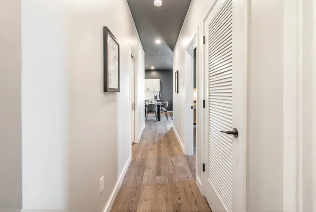 a bedroom with a bed and painting on the wall