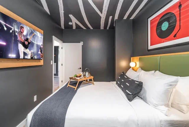 a bedroom with a large bed and a chandelier