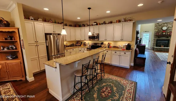 a kitchen with stainless steel appliances a stove a sink a refrigerator and cabinets