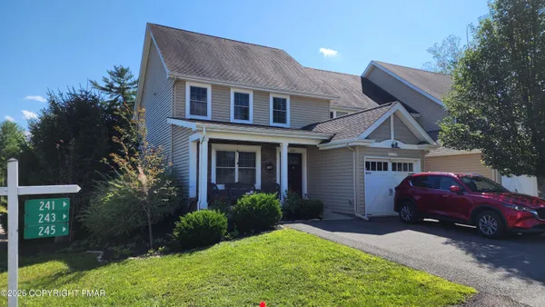 a front view of a house with a garden