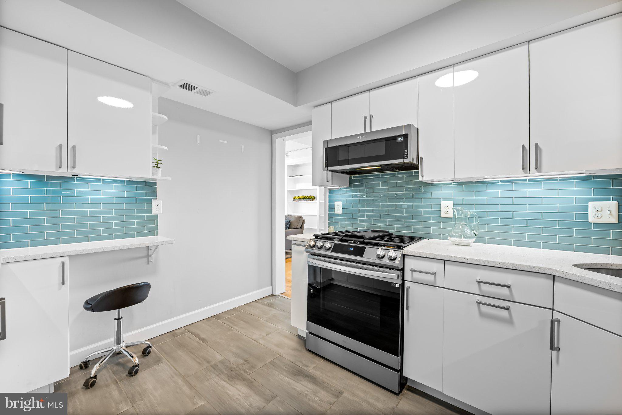 200 Cross Keys Road, Unit R 68 Baltimore, MD 21210 - Photo 6 of 30 Sleek kitchen with gas stove & vibrant backsplash