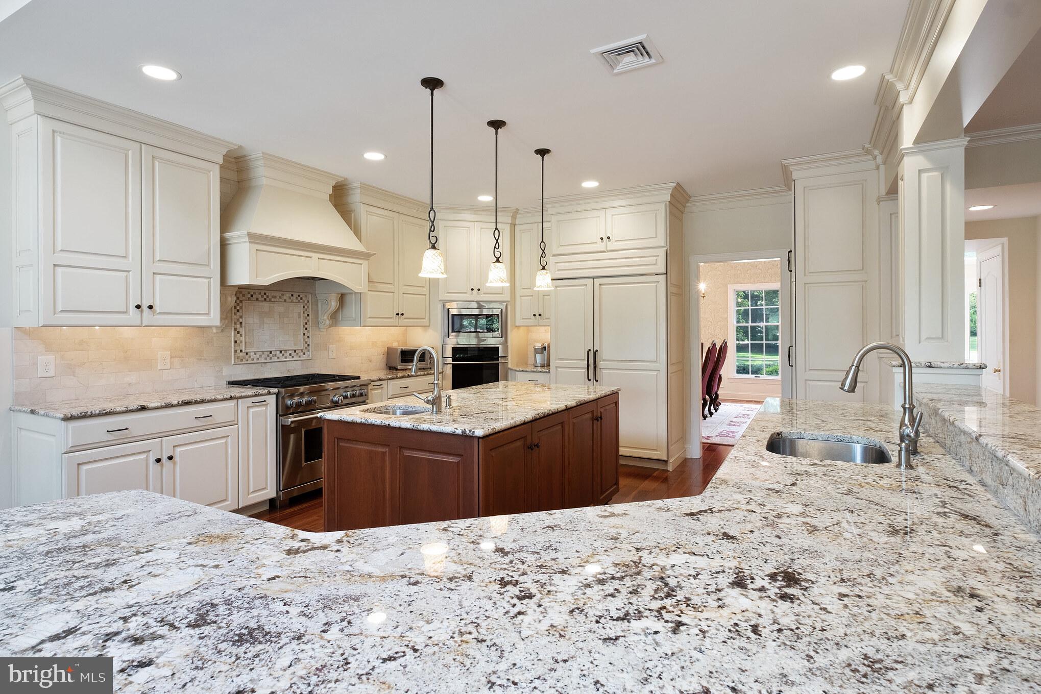 702 Commonwealth Drive Moorestown, NJ 08057 - Photo 11 of 34 a large kitchen with kitchen island granite countertop a sink stove and refrigerator